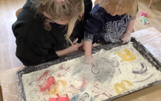 messy activities as nursery staff work with children during settling in sessions